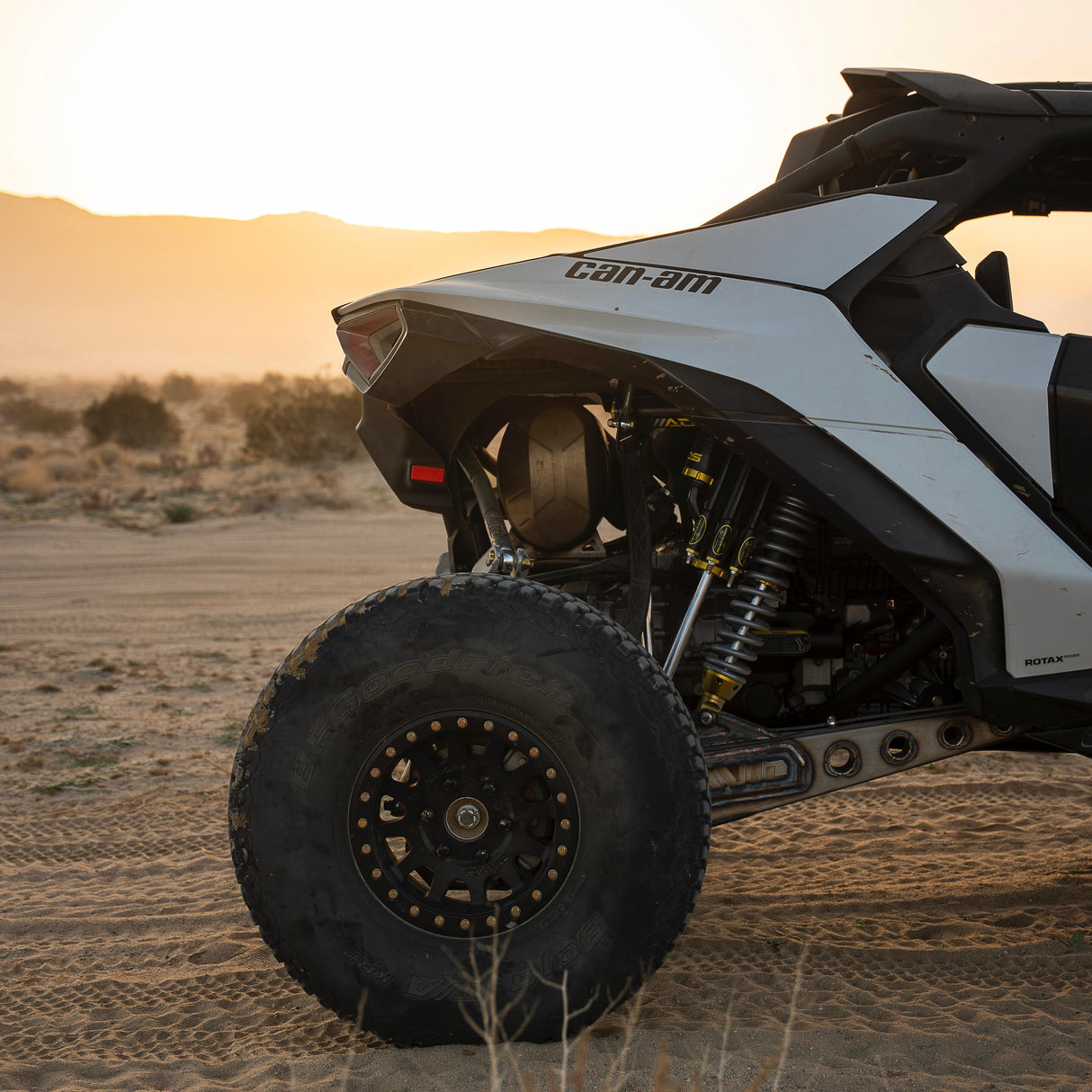 AVID Racing Can-Am Maverick R Rear Race Trailing Arm and Dual Shock Conversion Kit mounted on vehicle in the desert