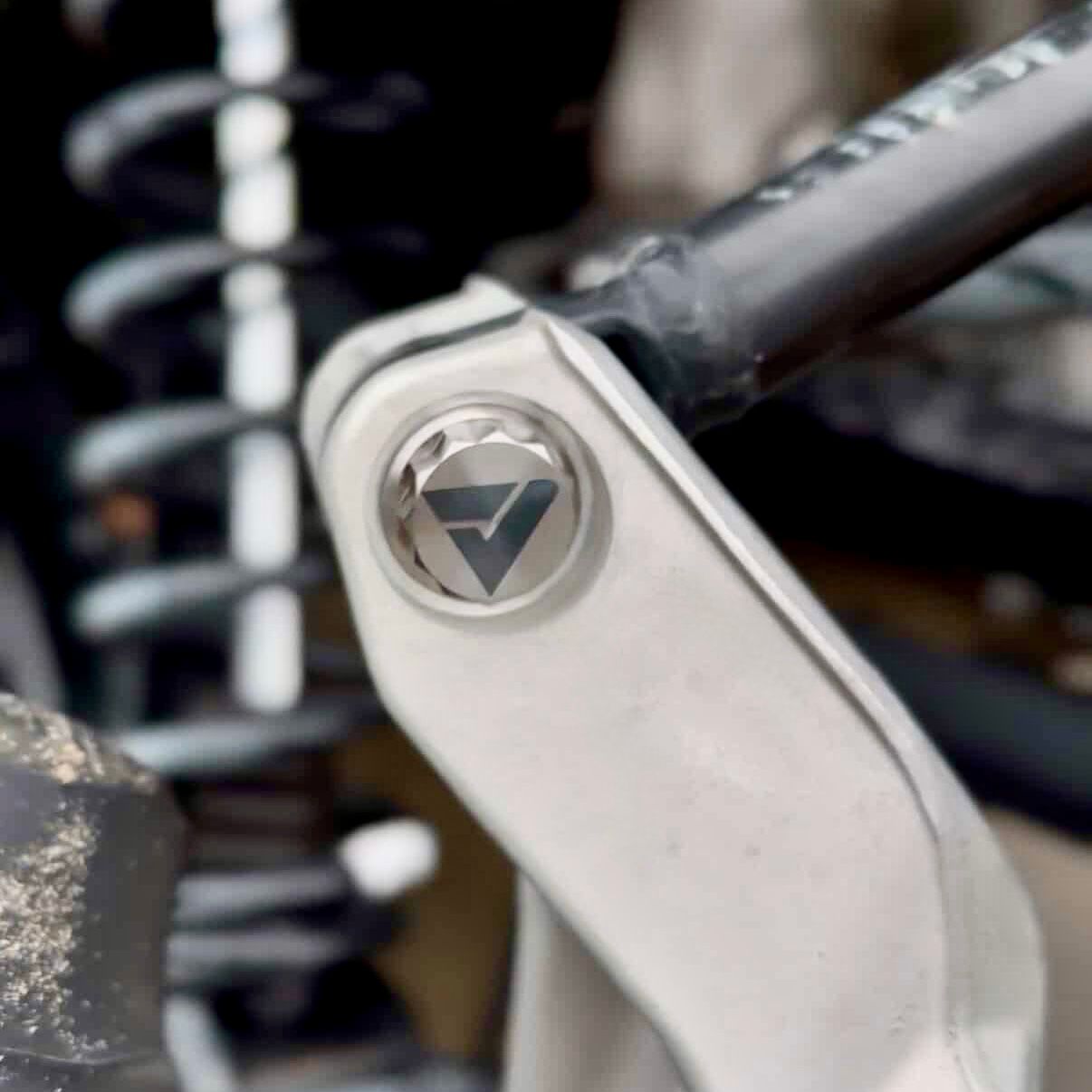 AVID Racing Upper Control Arm Titanium Hardware Dress-Up Kit close up of bolt mounted on vehicle