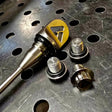 AVID Racing Can-Am Maverick R Dipstick and Titanium Hardware anodized gold on metal shop bench