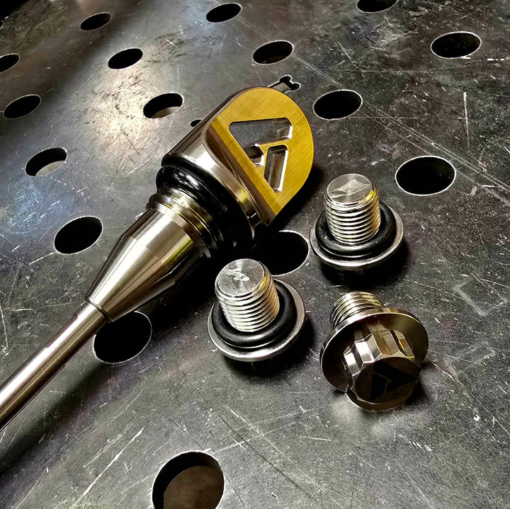 AVID Racing Can-Am Maverick R Dipstick and Titanium Hardware anodized gold on metal shop bench