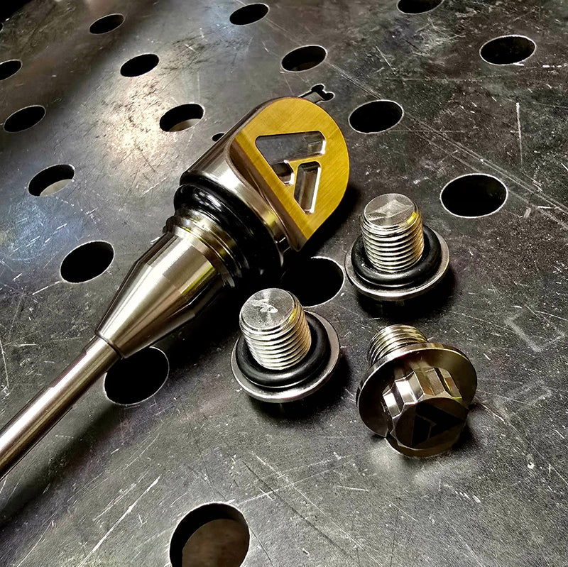 AVID Racing Can-Am Maverick R Dipstick and Titanium Hardware anodized gold on metal shop bench