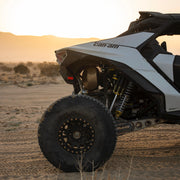AVID Racing Can-Am Maverick R Rear Race Trailing Arm and Dual Shock Conversion Kit mounted on vehicle in the desert