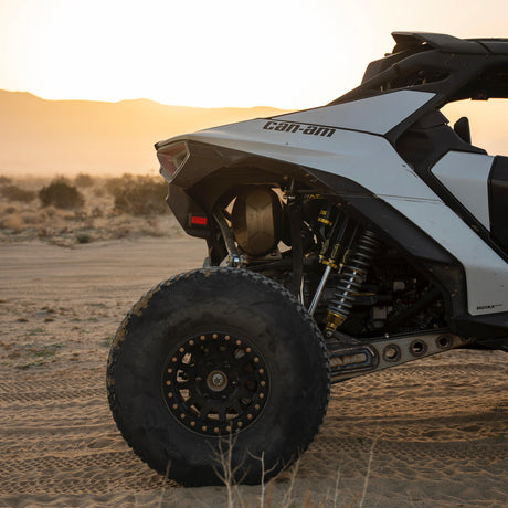 AVID Racing Can-Am Maverick R Rear Race Trailing Arm and Dual Shock Conversion Kit mounted on vehicle in the desert