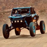 AVID Racing Polaris Pro R 80" Baja front suspension kit mounted on vehicle racing in the Baja desert race