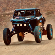 AVID Racing Polaris Pro R 80" Baja front suspension kit mounted on vehicle racing in the Baja desert race