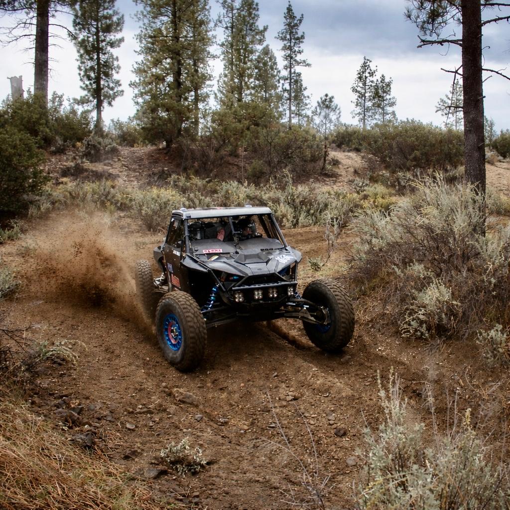 AVID Racing Polaris Pro R 80" Baja front suspension kit mounted on vehicle racing on dirt track