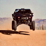 AVID Racing Polaris Pro R LT80" Baja Front Suspension Kit mounted on vehicle jumping in baja desert race