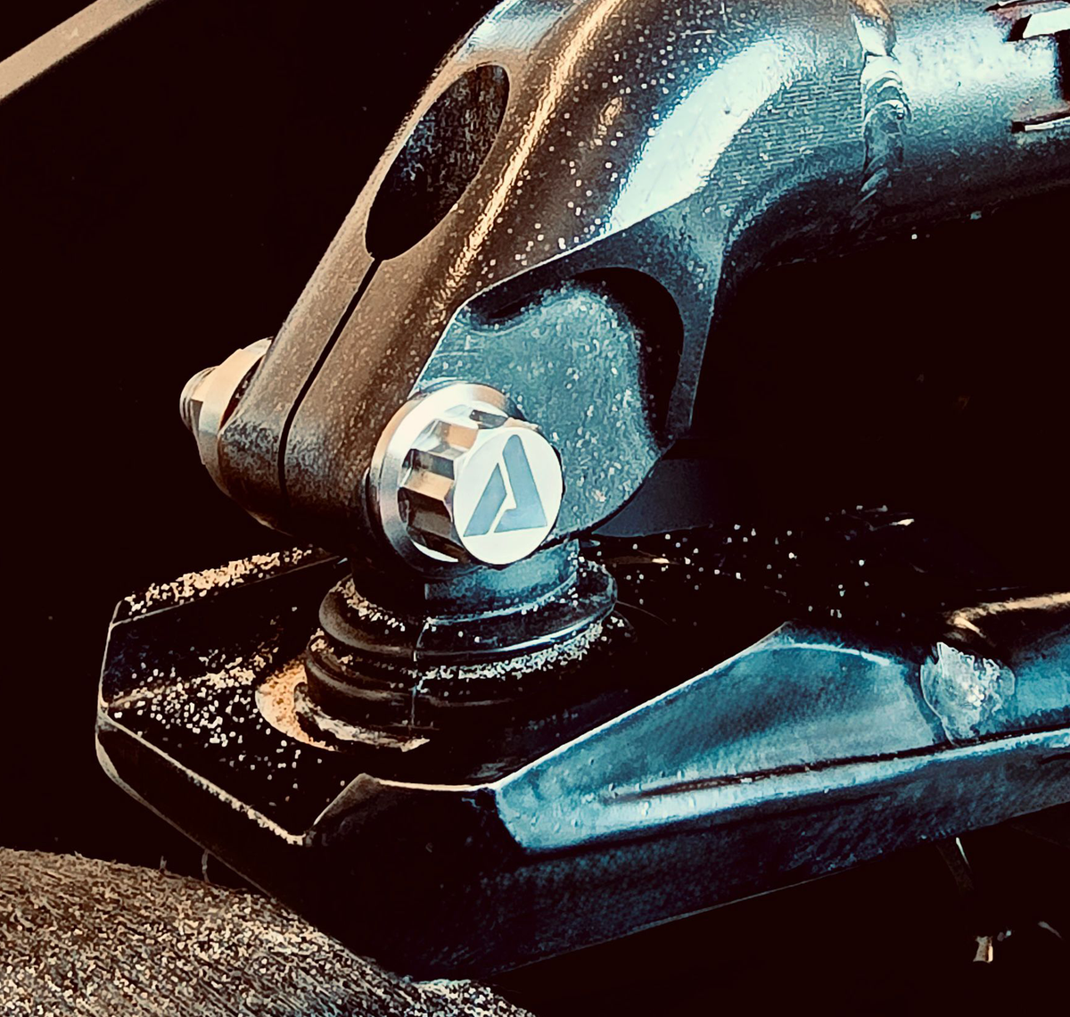 AVID Racing Upper Control Arm Titanium Hardware Dress-Up Kit close up of bolt mounted on vehicle