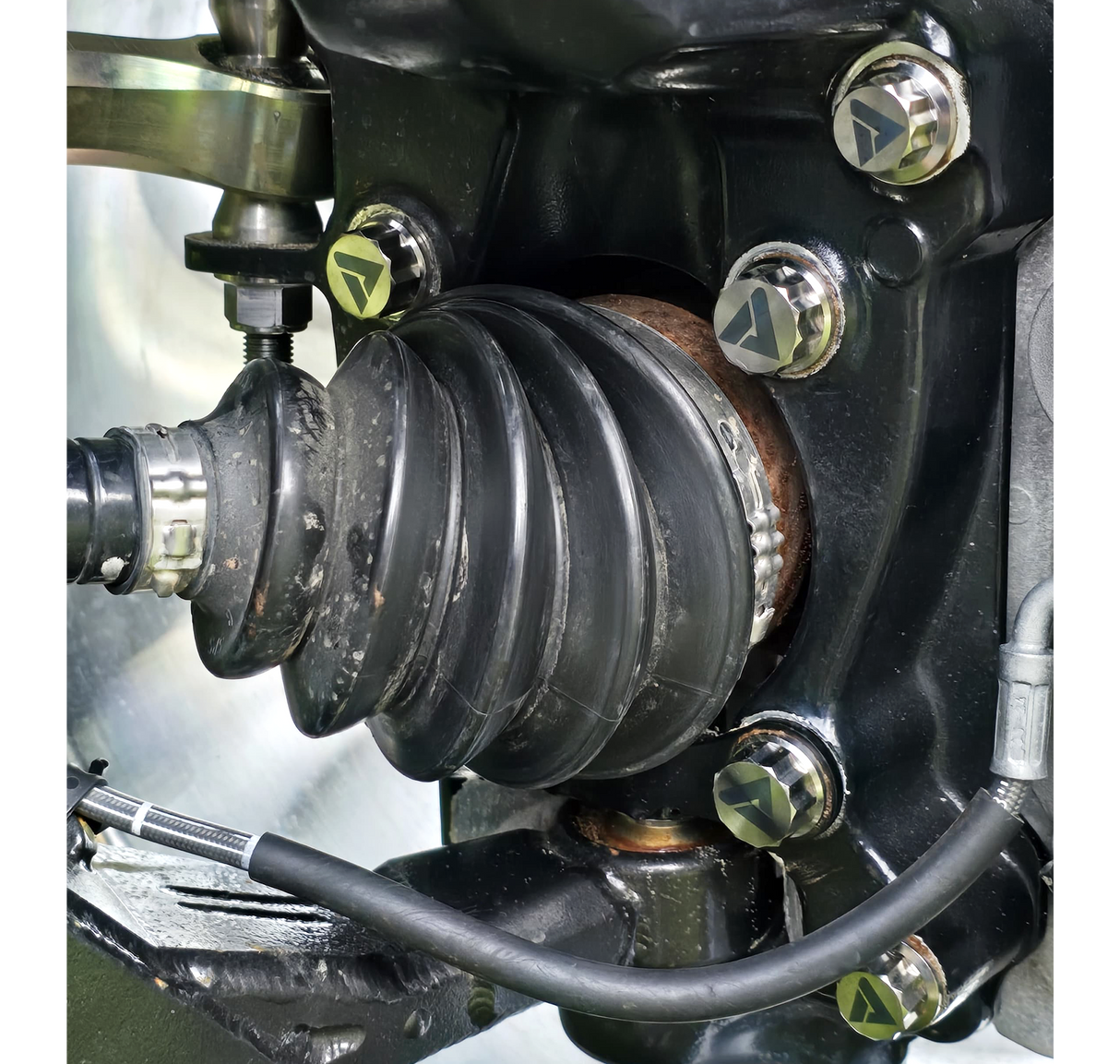 AVID Racing Can-Am Maverick R Stock Front Control Arm Titanium Bolt Hardware Kit mounted on vehicle