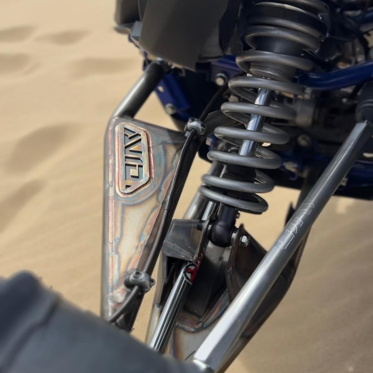 AVID Racing Yamaha YXZ1000 72" Front Long Travel Suspension Kit with stock knuckles mounted on vehicle with logo on the left side of the vehicle