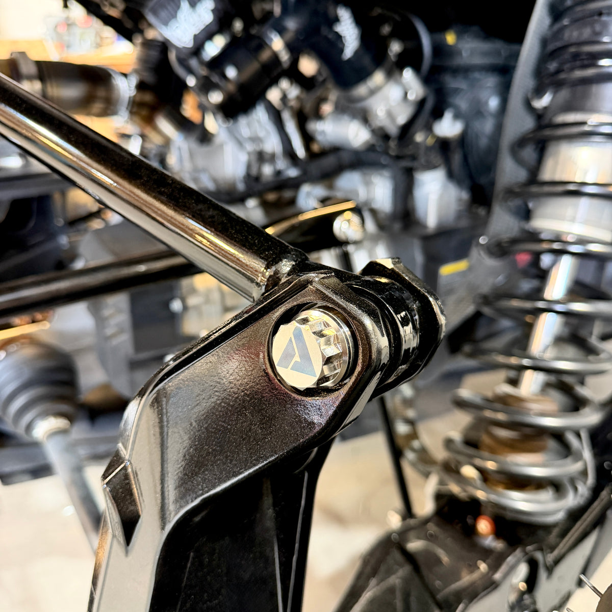 Can-Am Maverick R billet radius rod plate hardware detail