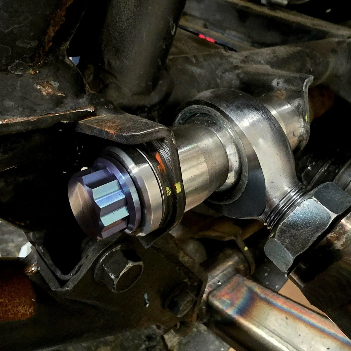 AVID Racing weld washer mounted on UTV suspension with a 12 point anodized titanium hardware