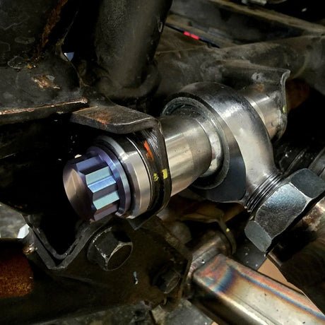 AVID Racing weld washer mounted on UTV suspension with a 12 point anodized titanium hardware